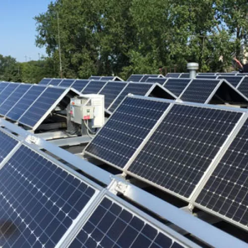 Mayor Peter Lindstrom shows off solar panels atop Falcon Heights City Hall