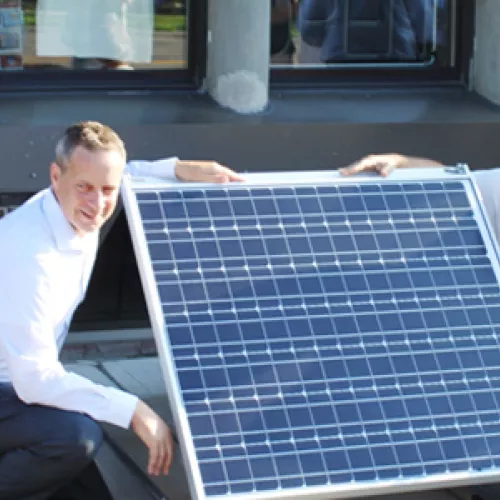 Scott Cramer (right) is ready for a new community solar project on his company's roof