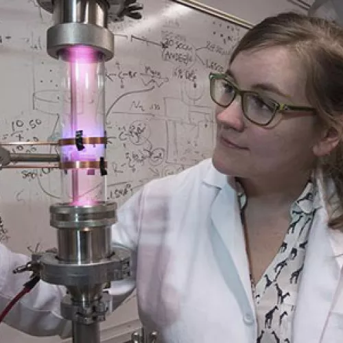 University of Minnesota researcher Samantha Ehrenberg uses a plasma reactor to create silicon nanoparticles that are the key ingredient in the solar concentrators. Credit: Patrick O'Leary, University of Minnesota