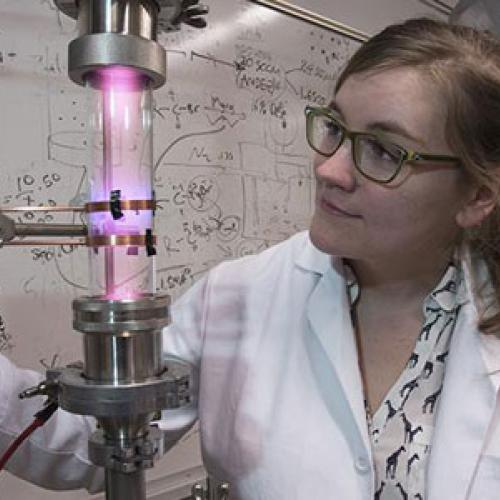 University of Minnesota researcher Samantha Ehrenberg uses a plasma reactor to create silicon nanoparticles that are the key ingredient in the solar concentrators. Credit: Patrick O'Leary, University of Minnesota