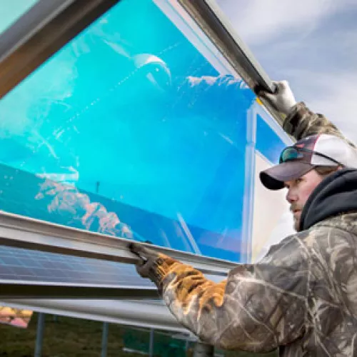 Worker with South Central Electric installs their new solar array. Photo by Trevor Cokley