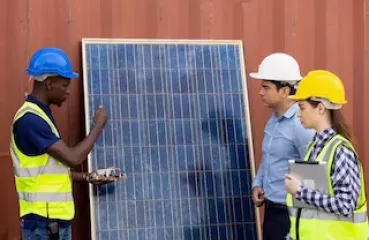 Team inspecting solar panel