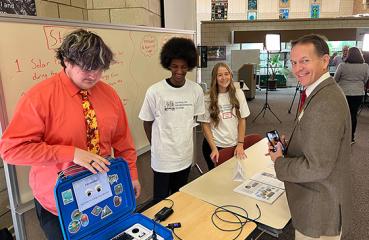 Peter Lindstrom and students at solar ribbon cutting event.