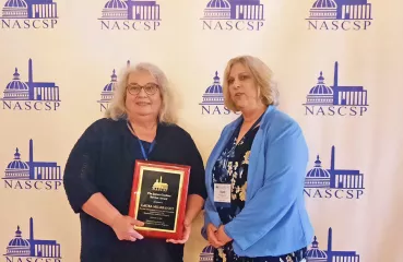 Laura Milbrandt accepting James Gardner Weatherization Award
