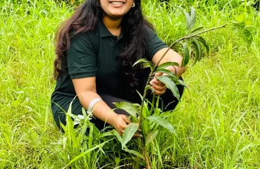 Salunke plants a mango plant.