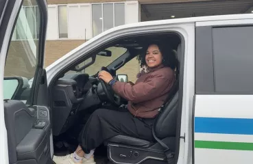 Imani driving an electric truck