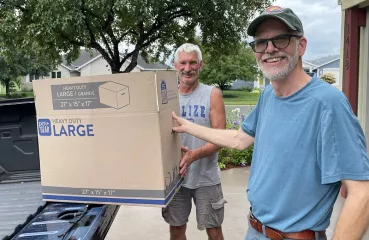 People unloading a box