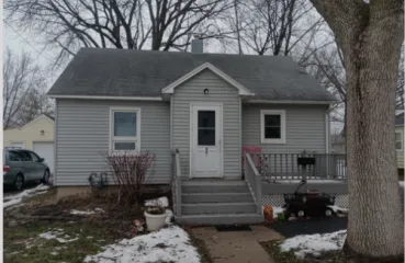 Picture of a grey single story home 