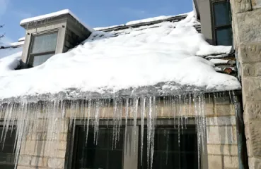 Ice dam on a home in winter