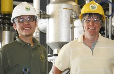 People in hard hats smiling at the camera