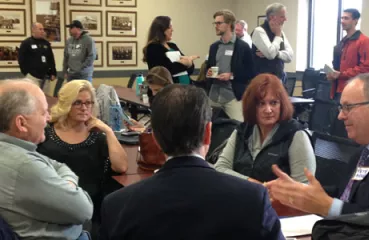 Attendees chatting about super exciting energy efficiency opportunities, all made possible by building benchmarking!