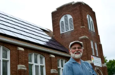 Tim Johnson, pastor of Cherokee Park United Church in St. Paul, says visitors frequently inquire about the church’s solar array. (Photo by Ken Paulman / Midwest Energy News)
