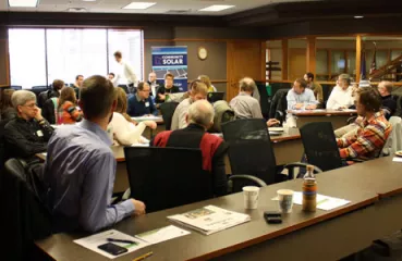 Attendees at the workshop learn about community solar gardens
