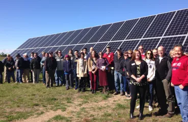 Tour participants gathered for a big group photo in front of Detroit Lake’s Community Solar Garden