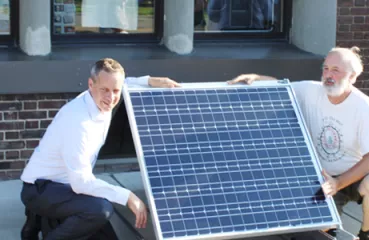 Scott Cramer (right) is ready for a new community solar project on his company's roof