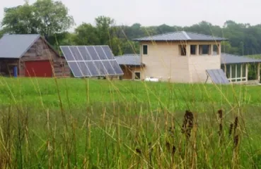 farm with solar panels surround by fields
