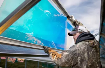 Worker with South Central Electric installs their new solar array. Photo by Trevor Cokley