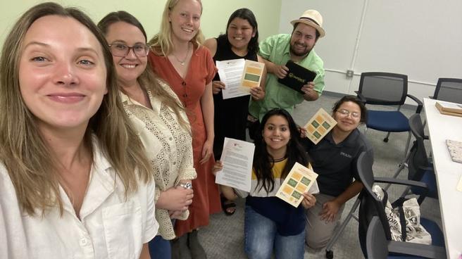 People smiling and holding certificates