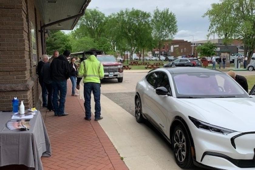 Attendees wait to drive an EV