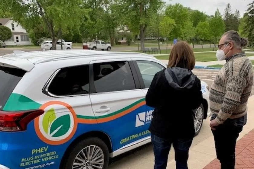 Attendees admire plug-in hybrid electric vehicle.