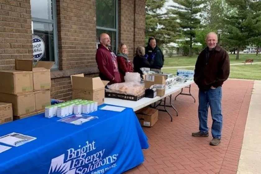 Event organizers and attendees at food table.