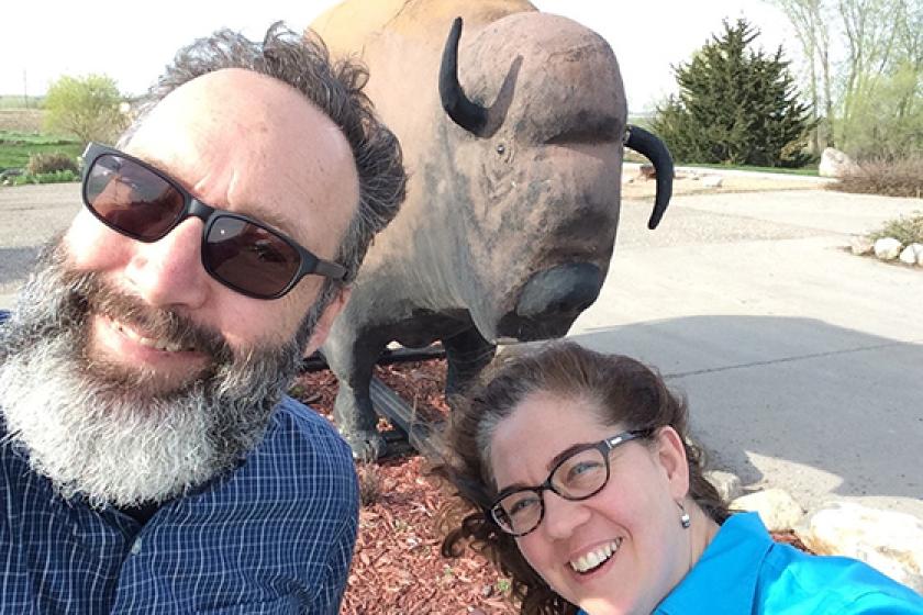 people with bison statue