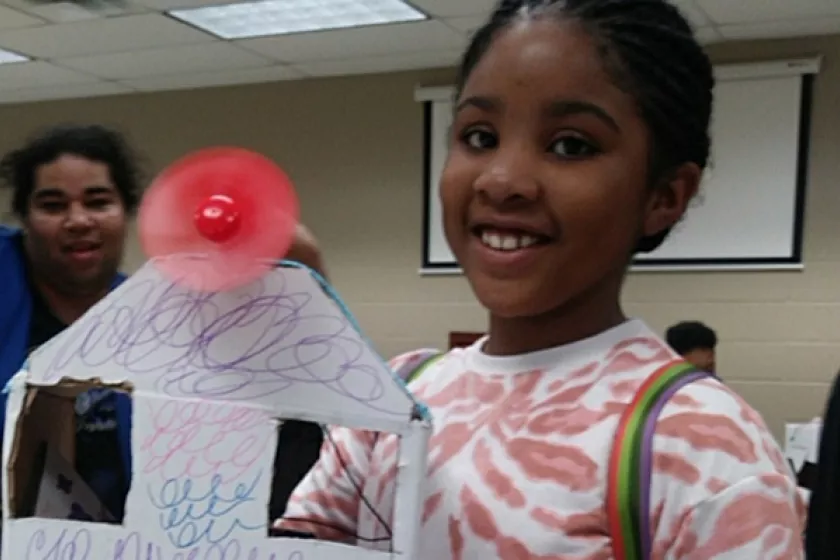 kid holding solar model home