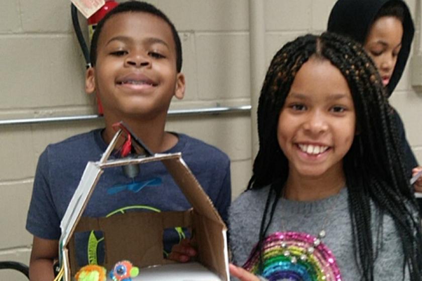 kids holding solar model home