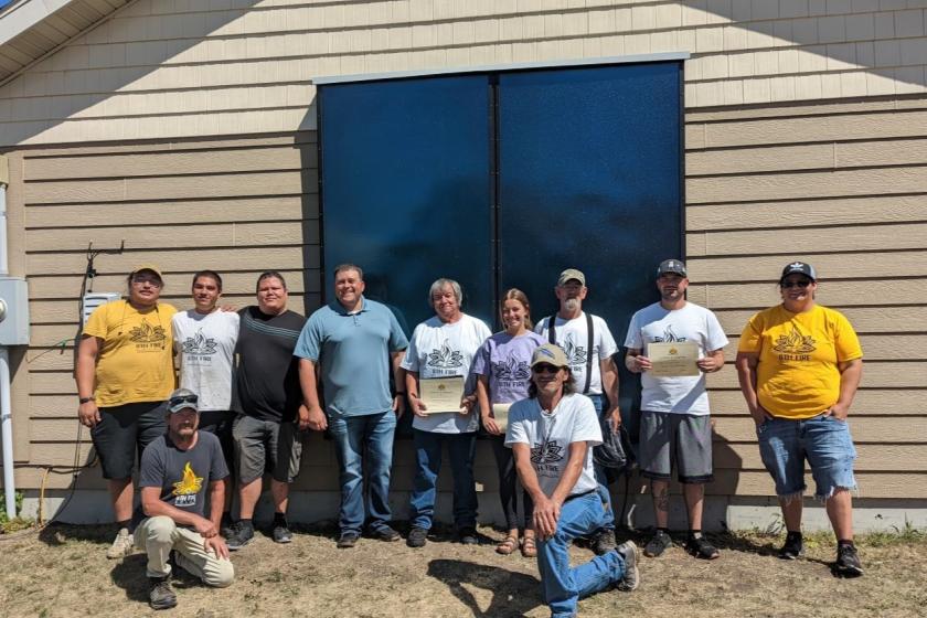 Group of Lower Sioux installers pose with 8th Fire Solar in front of newly installed solar thermal panel.