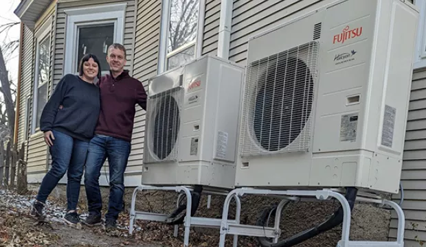 Kristen and William pose outside by their new HVAC system