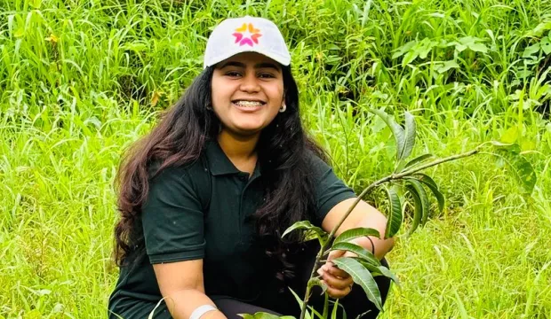Salunke plants a mango plant.