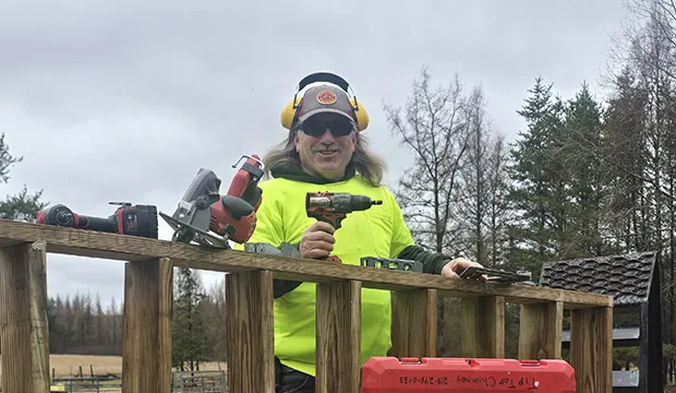 Richard Pierce with power tools outside