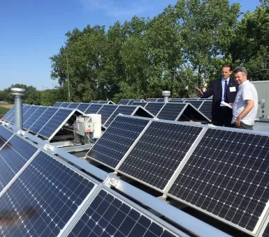 Mayor Peter Lindstrom shows off solar panels atop Falcon Heights City Hall
