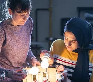 Iman Deriche, senior at Irondale High School, studies solar energy concepts with Andrea Abeln, environmental science teacher and clean energy advocate.