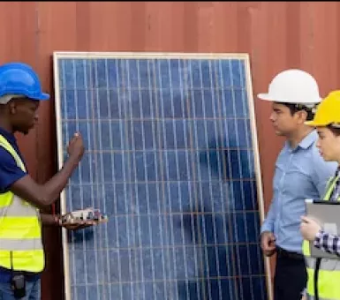 Team inspecting solar panel