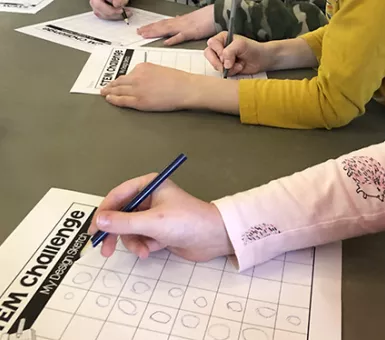 children filling out STEM challenge