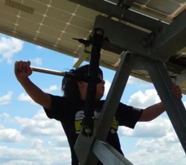 The Popp family children are learning first-hand how solar photovoltaic panels and their wind turbine create energy on their farm